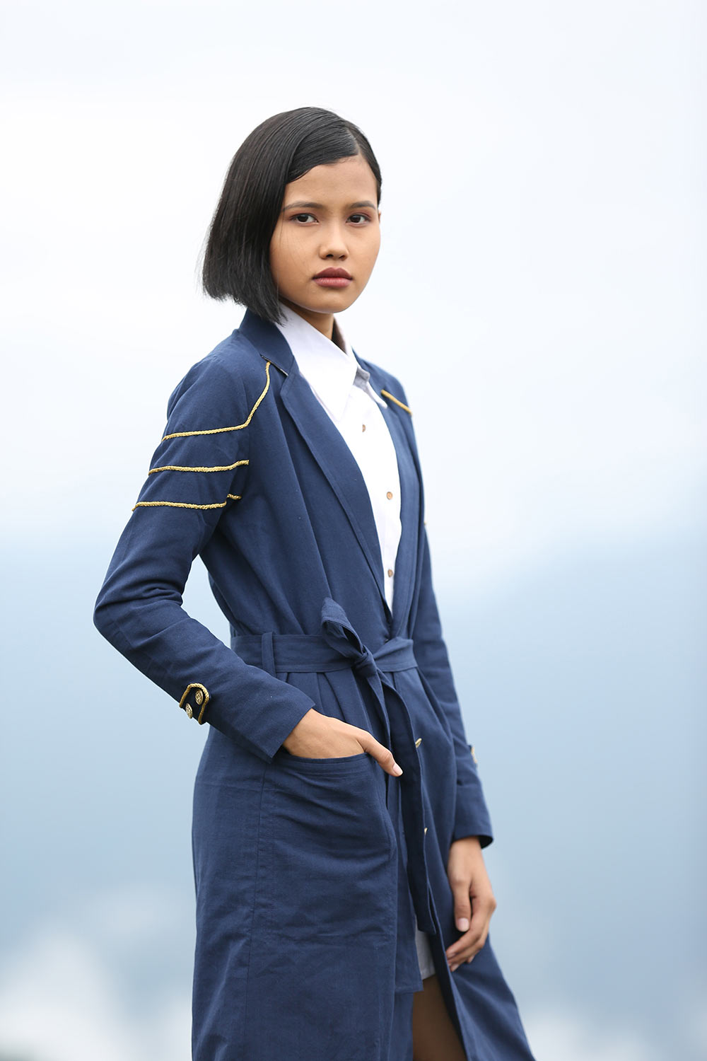 Model wearing Handwoven Trench coat with golden trims, designed by Khumanthem Atelier