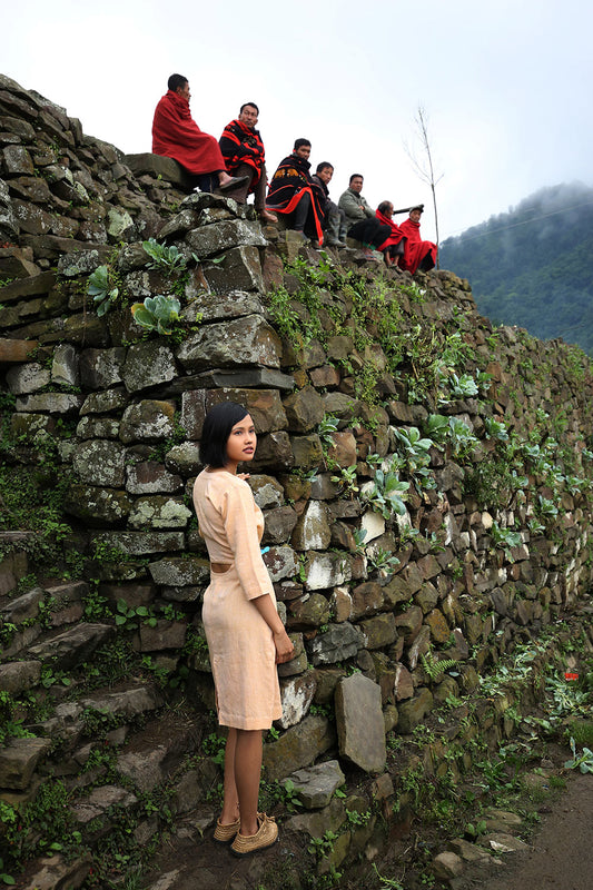 model posing wearing Handwoven Fitted dress with crescent cut out back, designed by Khumanthem Atelier