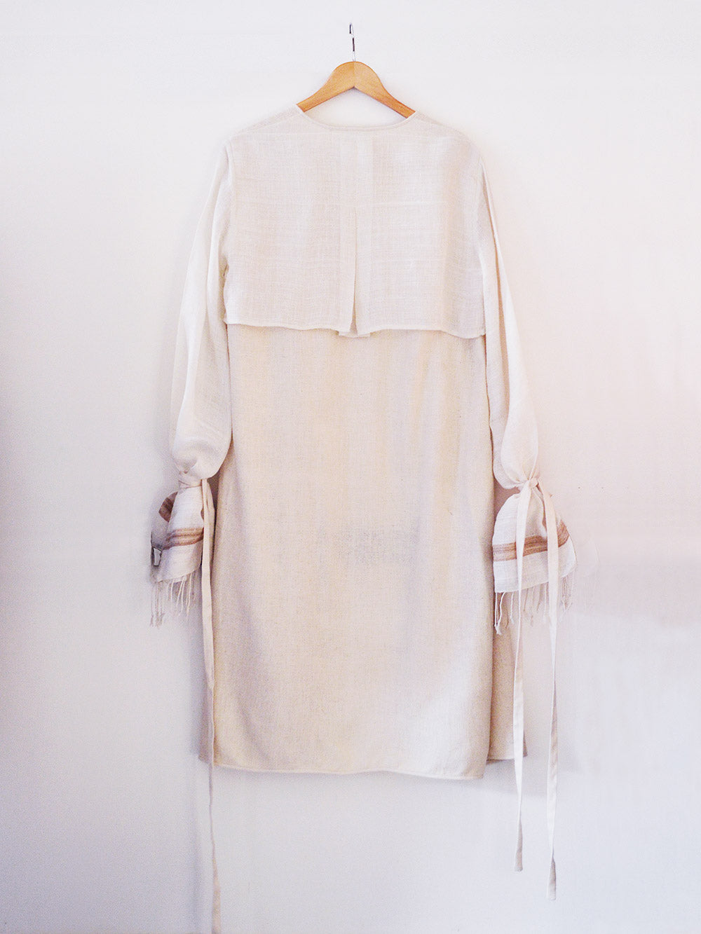Back view of off white handwoven silk coat, designed by Khumanthem Atelier