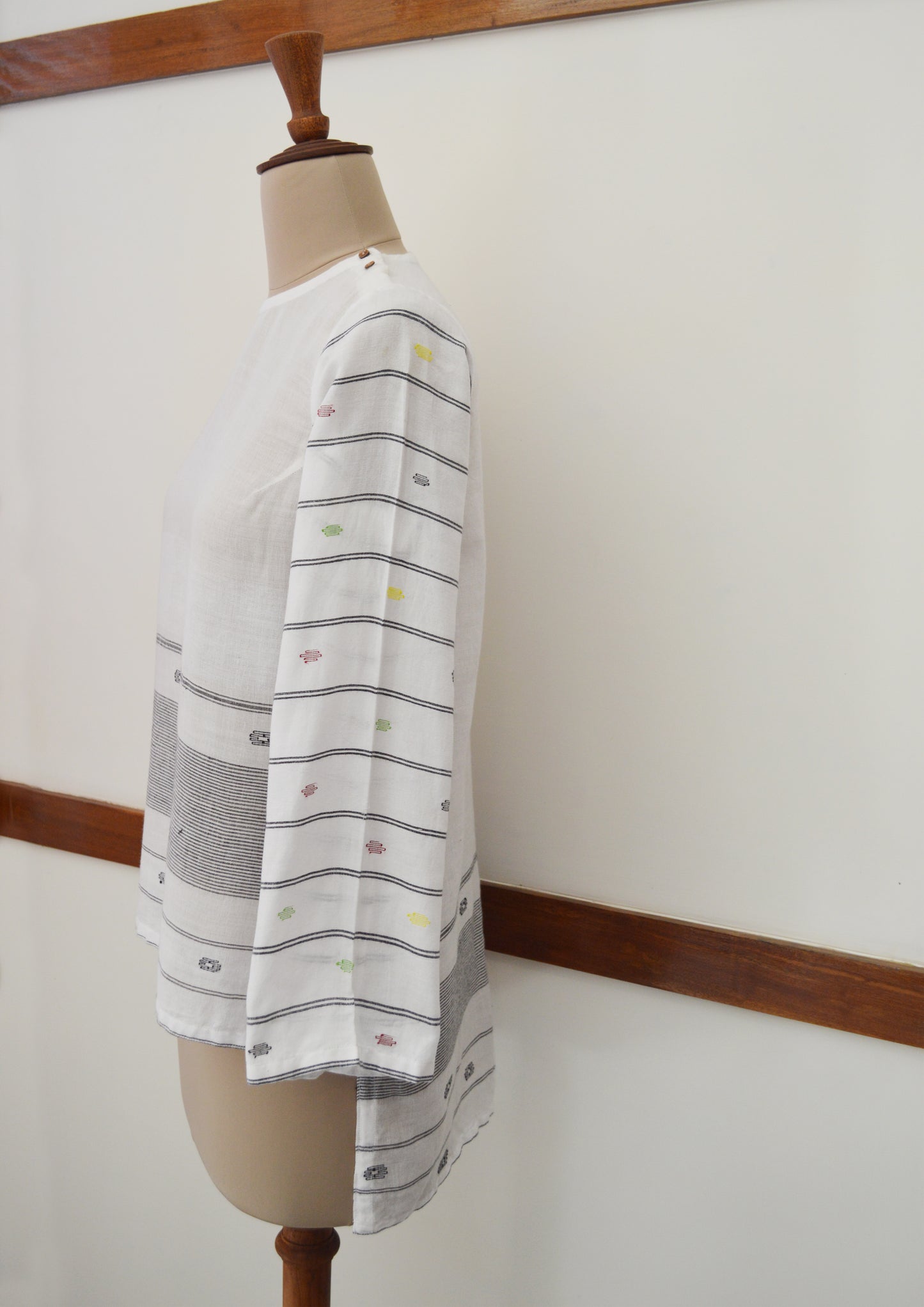 Close up side view of hanger shoot of Handwoven cotton full sleeves top with extra weft designed by Khumanthem Atelier