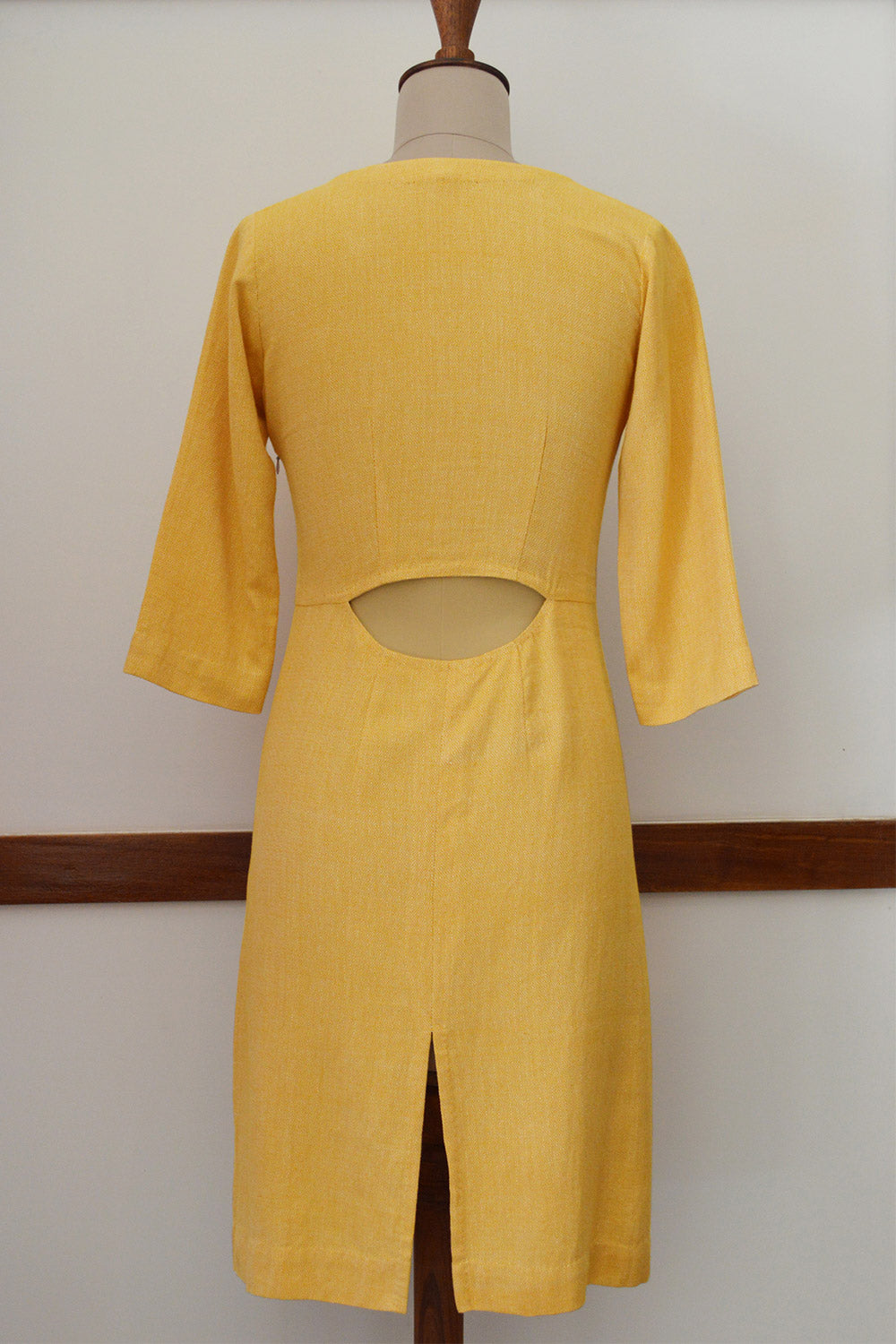 Close up back view of the Handwoven Fitted dress with crescent cut out back, designed by Khumanthem Atelier