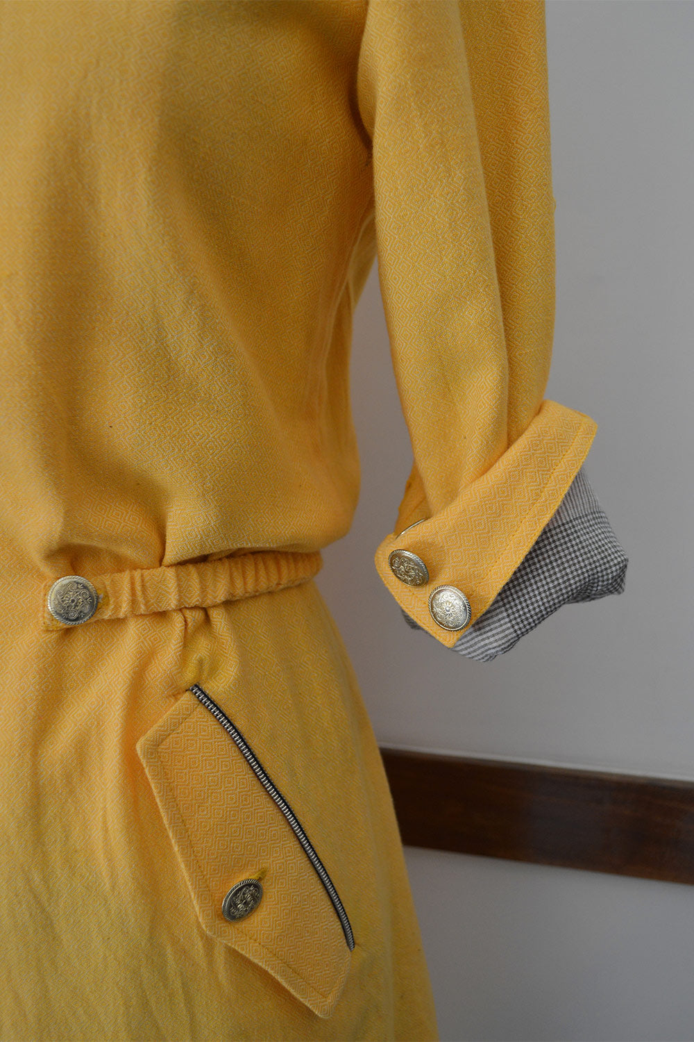 Close up side view of Handwoven diamond weave coat dress with front flap pockets, designed by Khumanthem Atelier