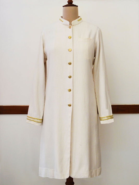 Close up front view of Handwoven Cotton long coat with golden trims and buttons, designed by Khumanthem Atelier