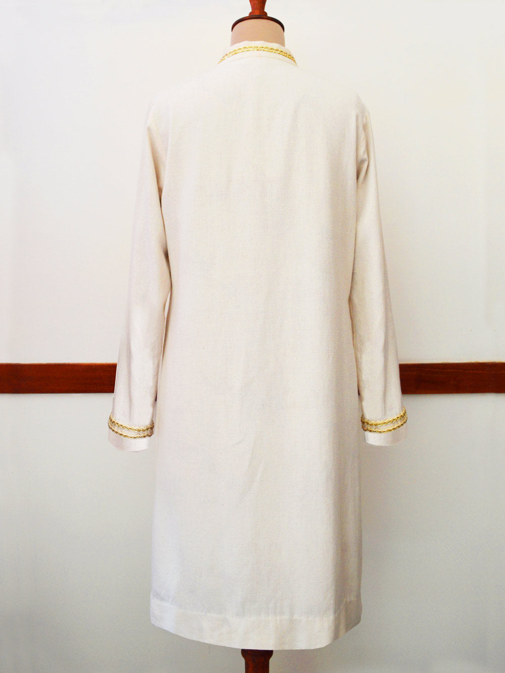 Close up back view of Handwoven Cotton long coat with golden trims and buttons, designed by Khumanthem Atelier