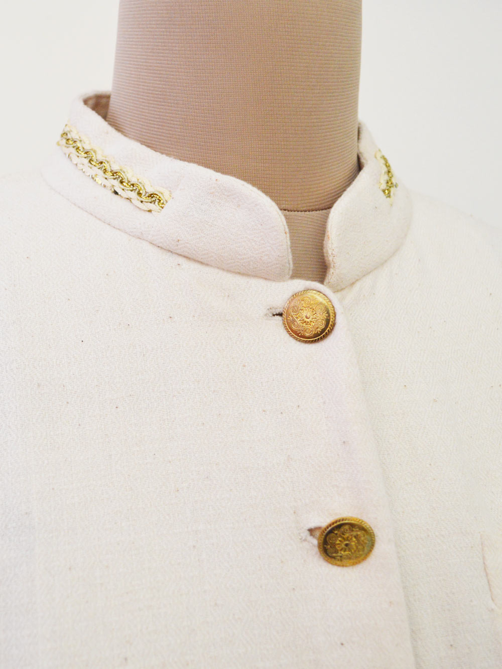 close up view of the golden lace details of the Handwoven Cotton long coat, designed by Khumanthem Atelier