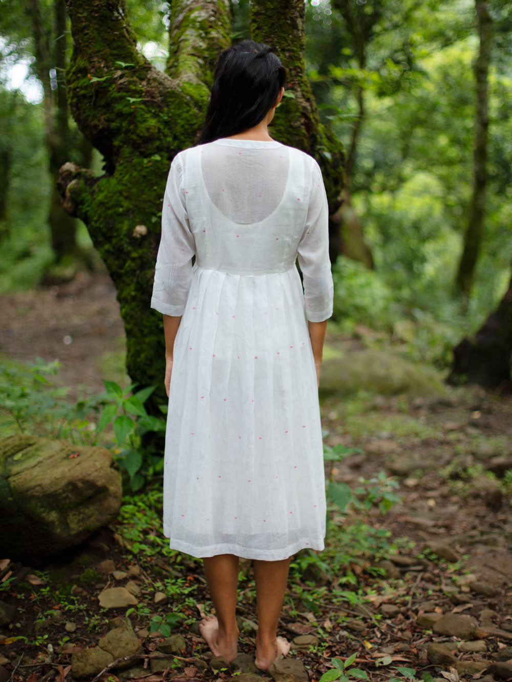 model wearing Handwoven Gathered hem quarter sleeves cotton dress, designed by Khumanthem Atelier, Back view