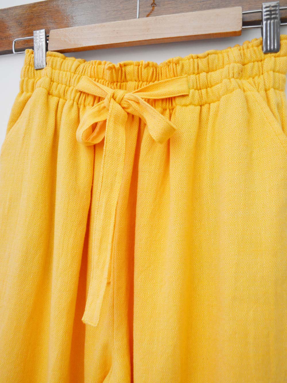 close view of the details of the tie-up pants, designed by Khumanthem Atelier
