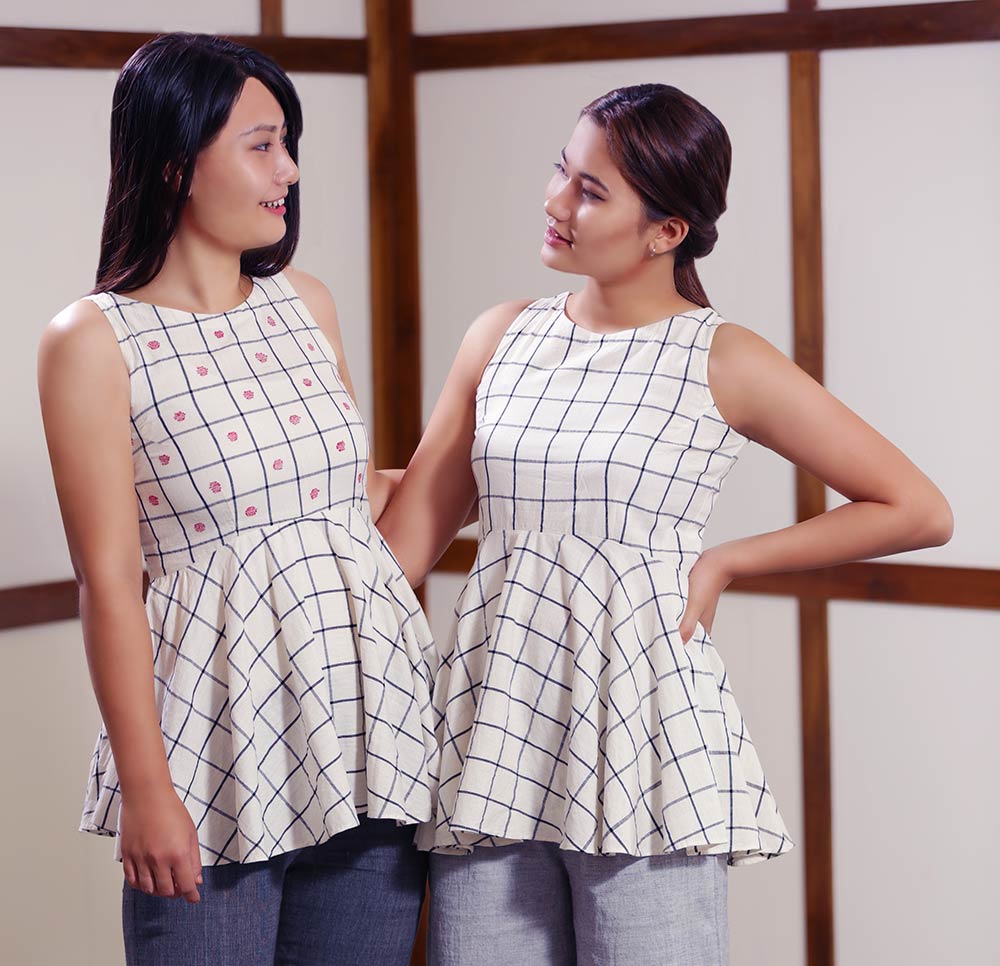 Models posing with checkered flare tops designed by Khumanthem Atelier