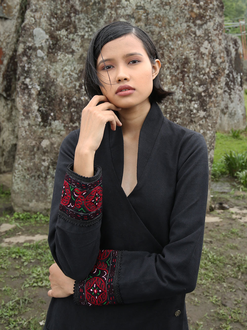 Close view of model wearing Hand embroidered long coat "mapan naiba motif", designed by Khumanthem Atelier