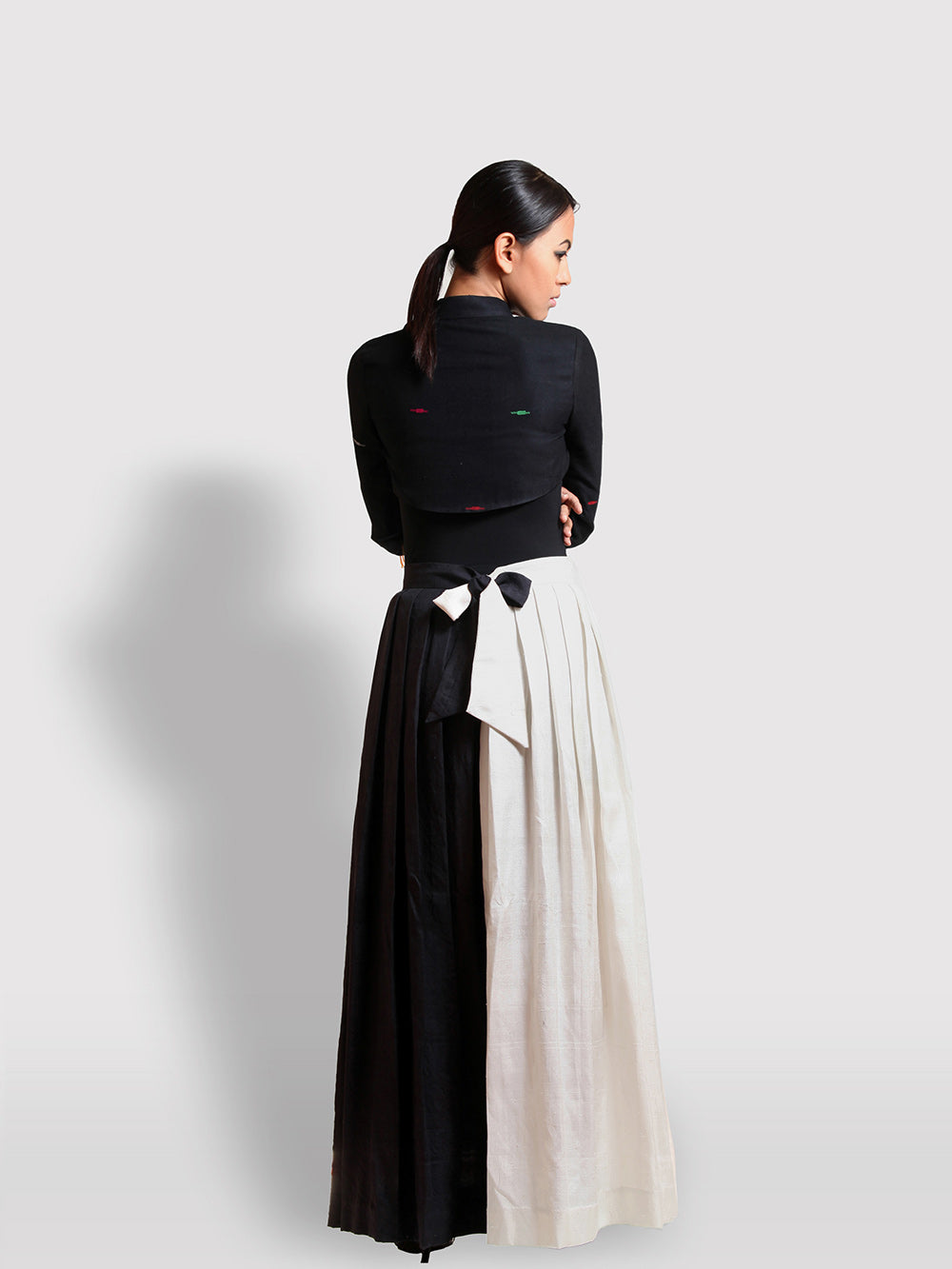 Back view of Hand embroidered Sheer Black Coat with sprinkle of creme flower with puffed shoulder handmade from mulberry silk designed by Khumanthem Atelier