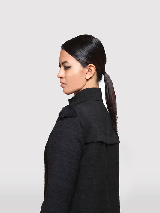 Side view of model wearing the Braided Shoulder Overcoat made from handwoven mulberry and Eri silk designed by Khumanthem Atelier