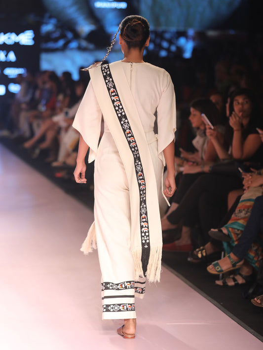 Back view of model ramp walking wearing Jumpsuits for women (Sha-Nga Motiff), designed by Khumanthem Atelier during the Lakme Fashion Week 2018