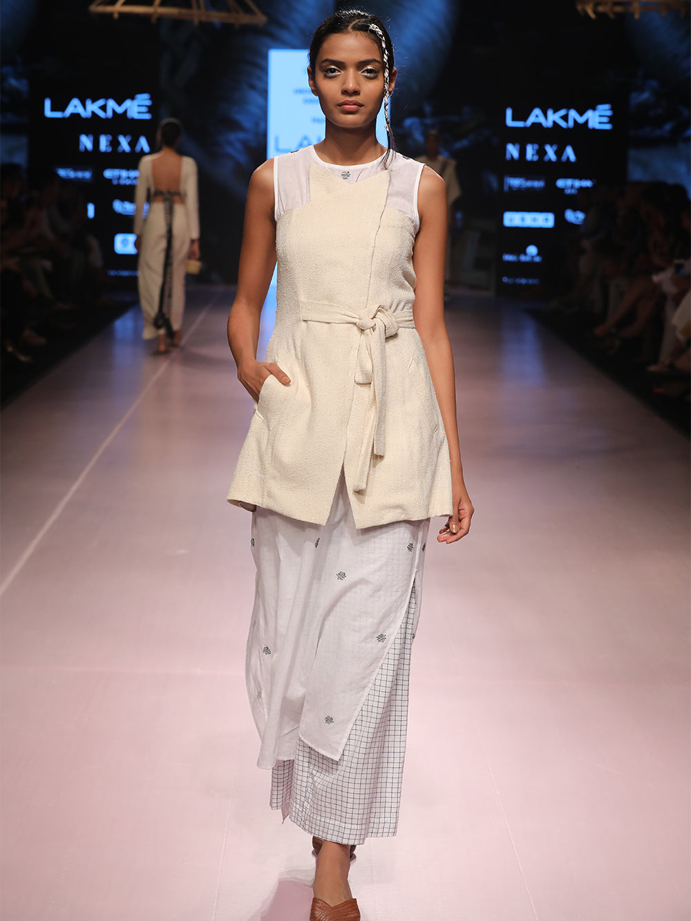 ramp walk front view of model wearing off white handwoven silk corset, designed by Khumanthem Atelier, during Lakme Fashion Week, 2018