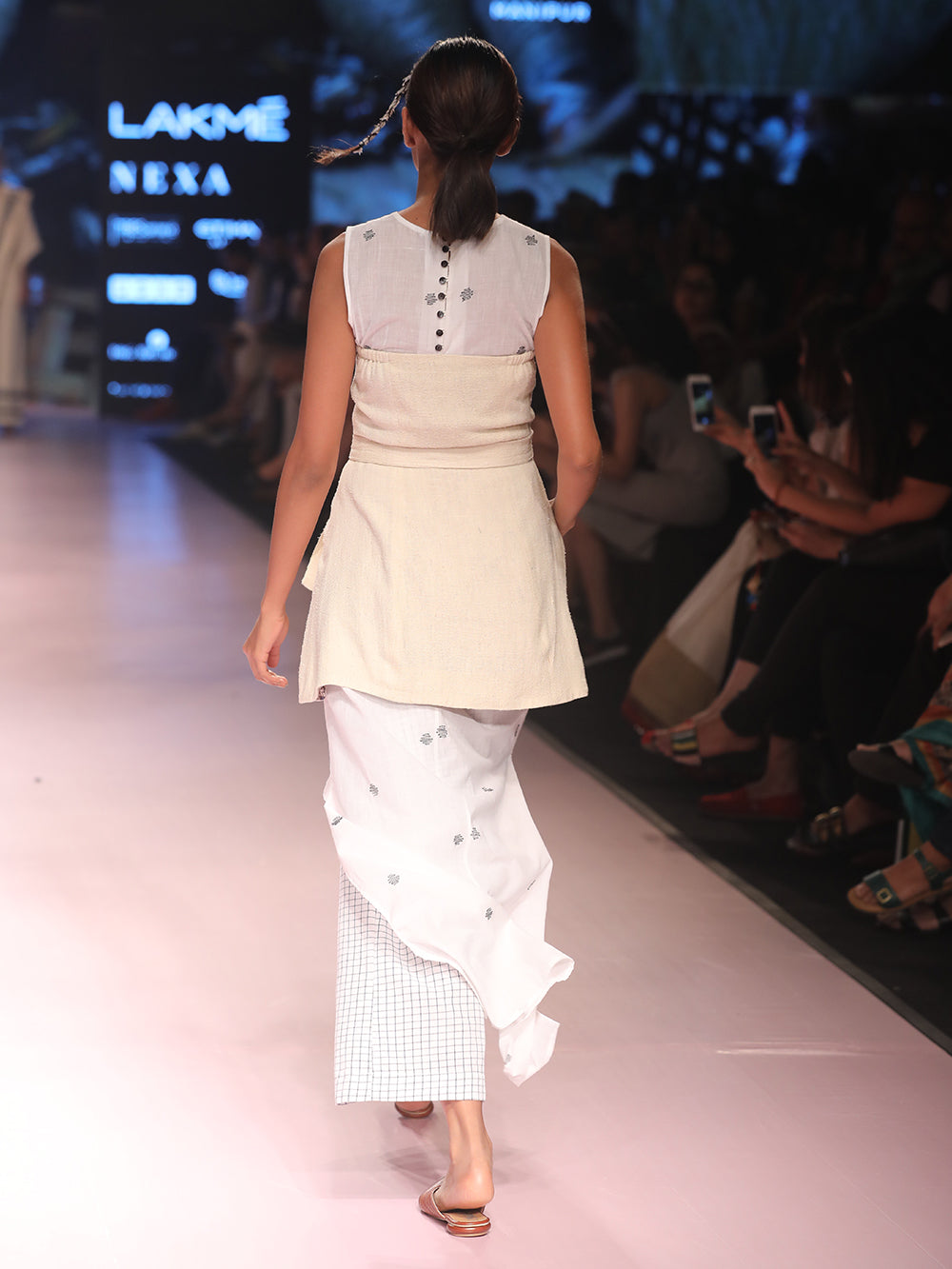 ramp walk back view of model wearing off white handwoven silk corset, designed by Khumanthem Atelier, during Lakme Fashion Week, 2018