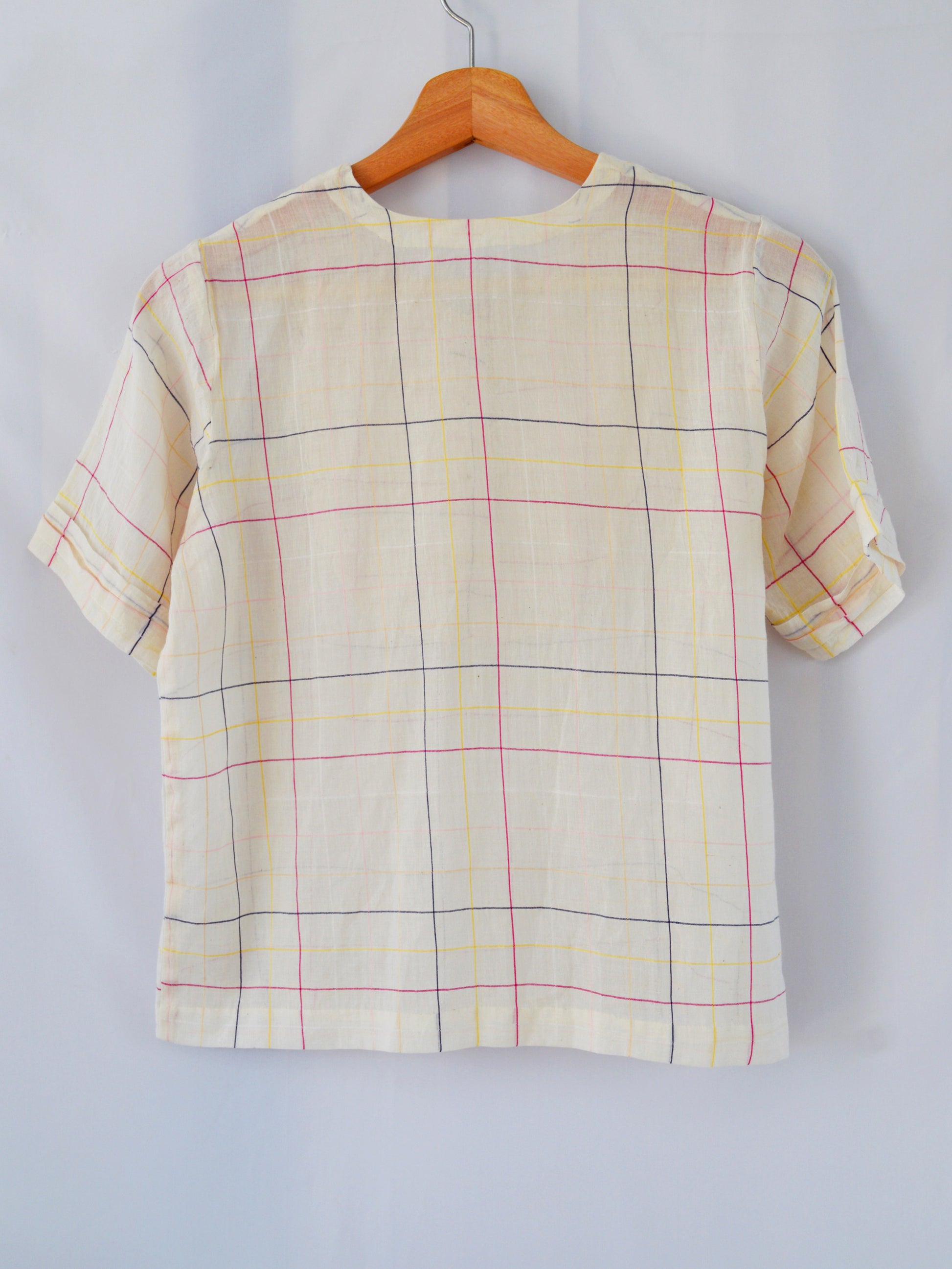 Back view of hanger shoot of Handwoven cotton top with pleated bib, designed by Khumanthem Atelier