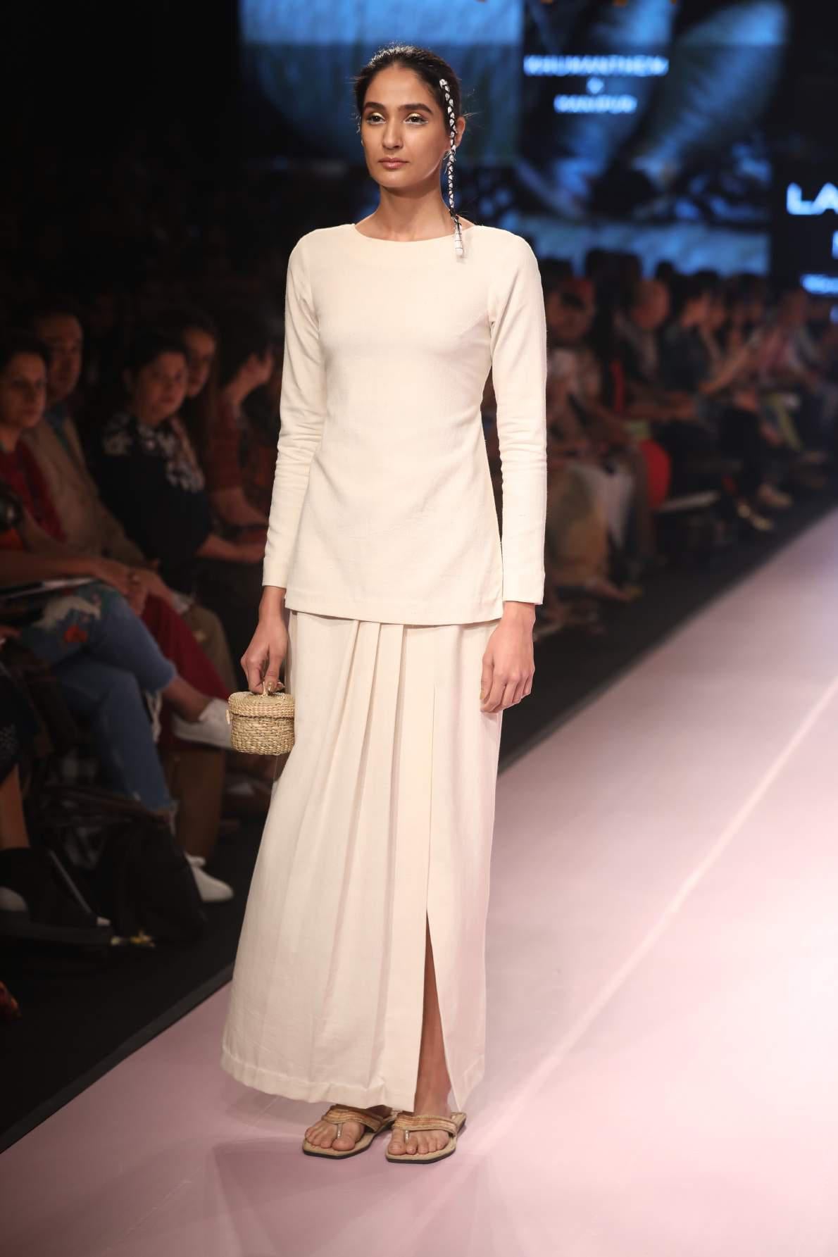 Ramp walk view of model wearing Handmade Tassled Tie-up blouse with (Shamee-Lanmee Motif), designed by Khumanthem Atelier during Lakme Fashion Week 2018
