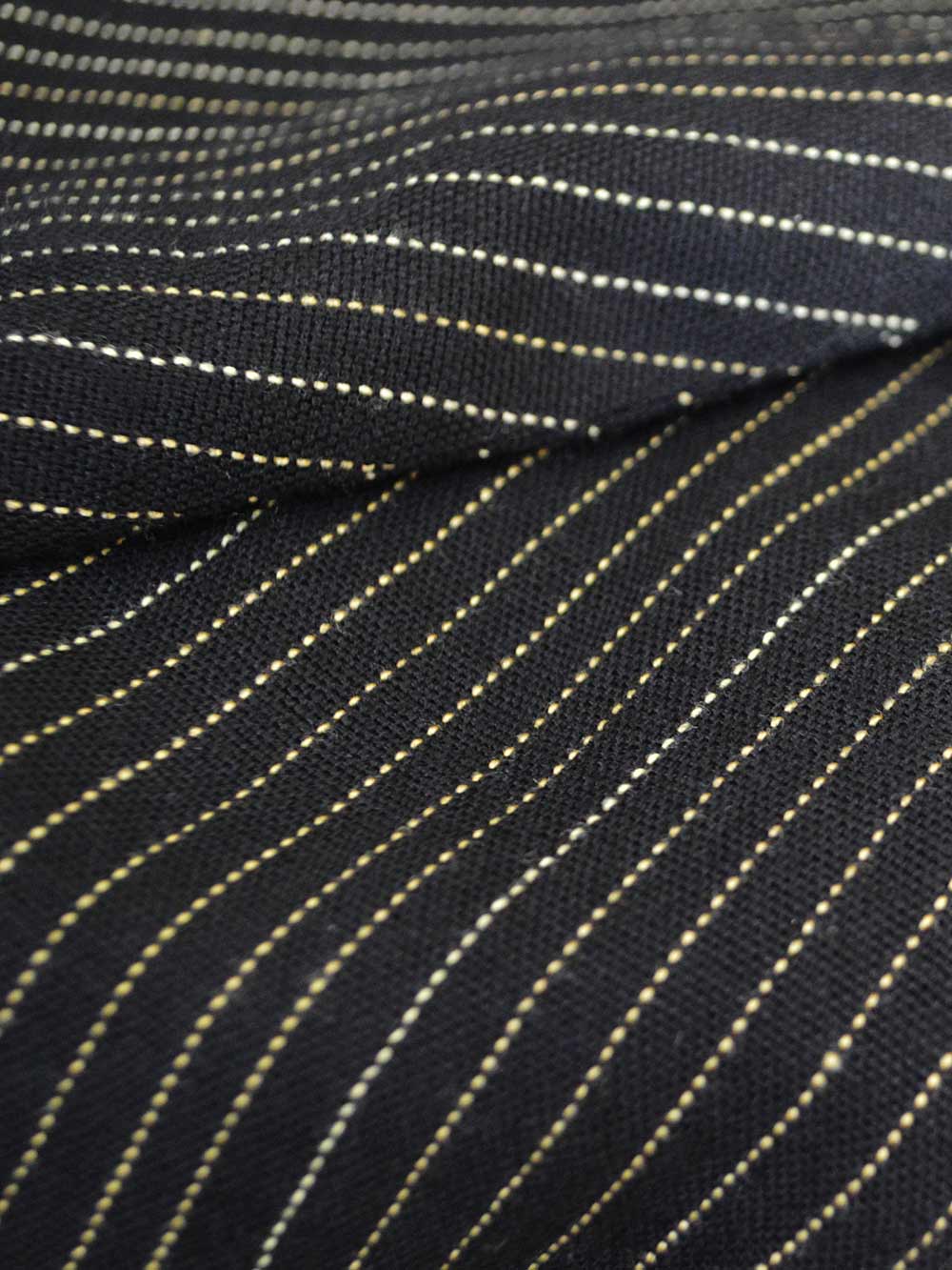 Close up view of the fabric of Pinstripe material designed by Khumanthem Atelier