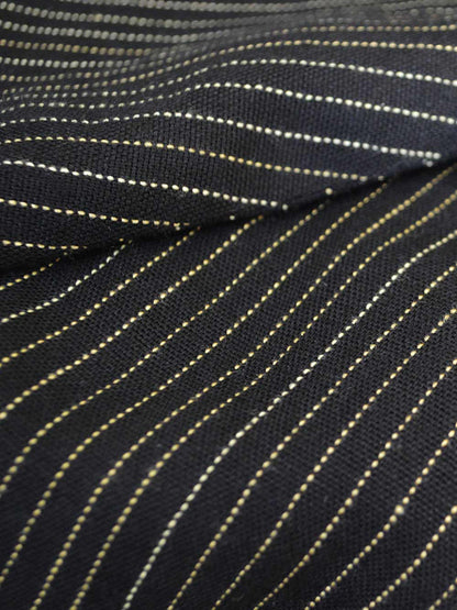 Close up view of the fabric of Pinstripe material designed by Khumanthem Atelier