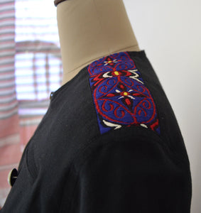 Close front view of Close view of the traditional Meitei patch work on the shoulder of Handwoven Military Style Cape coat, designed by Khumanthem