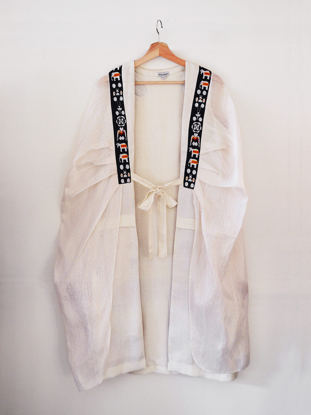 Unbleached white colour Cocoon coat with tie-up front (traditional Shamee-Lanmee Motif of Meitei), designed by Khumanthem Atelier