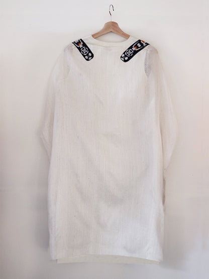 Back view of hanger shoot of Unbleached white colour Cocoon coat with tie-up front (traditional Shamee-Lanmee Motif of Meitei), designed by Khumanthem Atelier