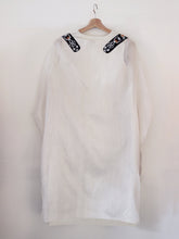 Load image into Gallery viewer, Back view of hanger shoot of Unbleached white colour Cocoon coat with tie-up front (traditional Shamee-Lanmee Motif of Meitei), designed by Khumanthem Atelier