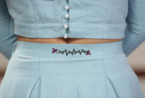 Close up view of the Handwoven cotton Pleated maxi skirt with floral embroidery, designed by Khumanthem Atelier