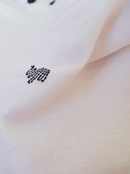 A close up look at the material and the embroidery of Handwoven sheer tunic dress with Hand embroidered details designed by Khumanthem Atelier