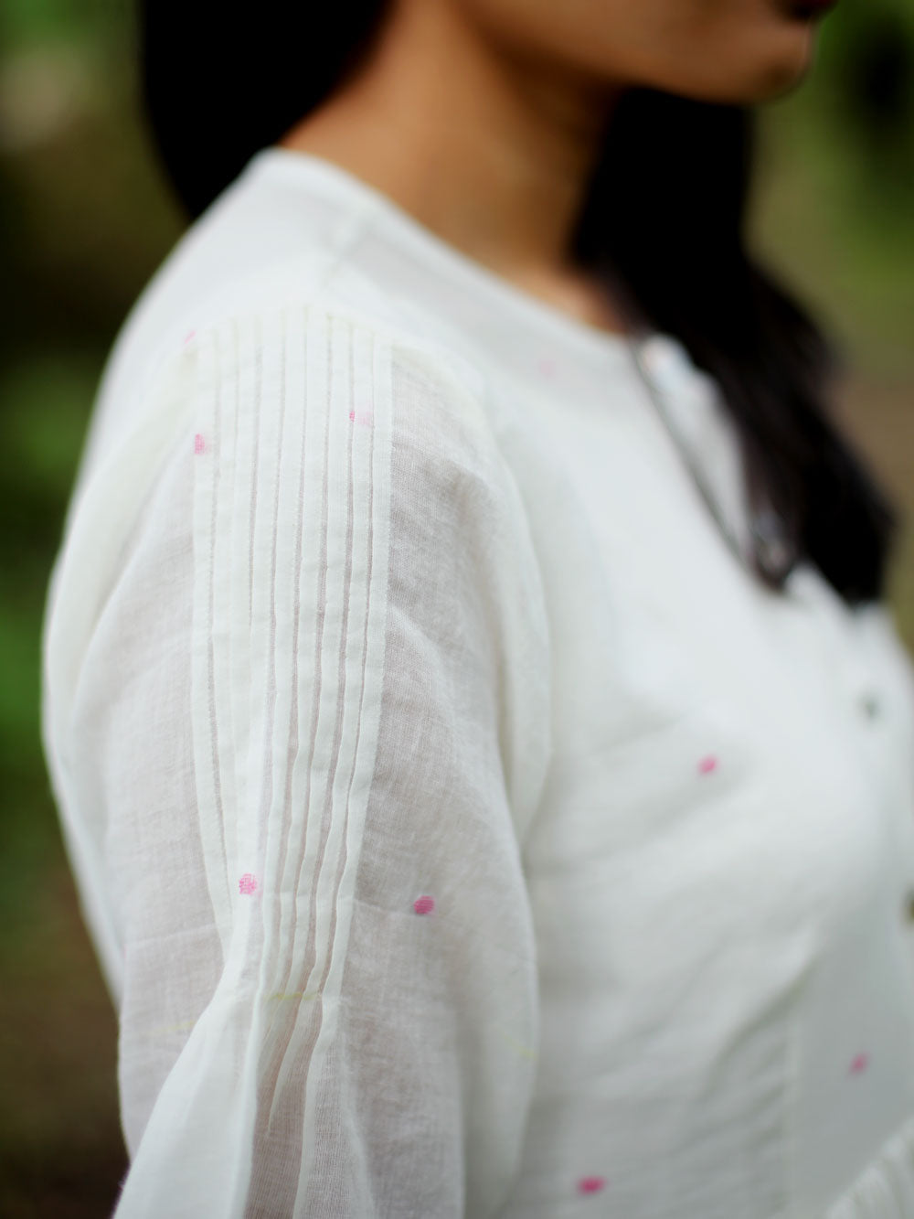 close up view Model wearing Handwoven Gathered waist cotton dress, designed by Khumanthem Atelier, side view