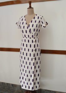 close up side view of hanger shoot of Handwoven Cross-over Ikat midi dress, designed by Khumanthem Atelier