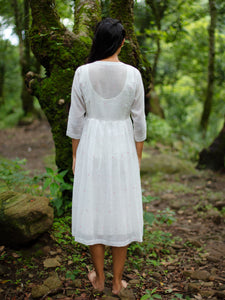 model wearing Handwoven Gathered hem quarter sleeves cotton dress, designed by Khumanthem Atelier, Back view