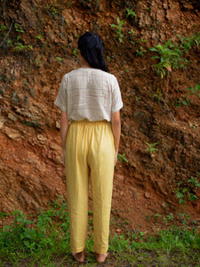 Back view of model wearing Handwoven cotton top with pleated bib, designed by Khumanthem Atelier