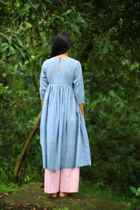 Back view of model wearing of Handwoven Gathered waist cotton dress, designed by Khumanthem Atelier