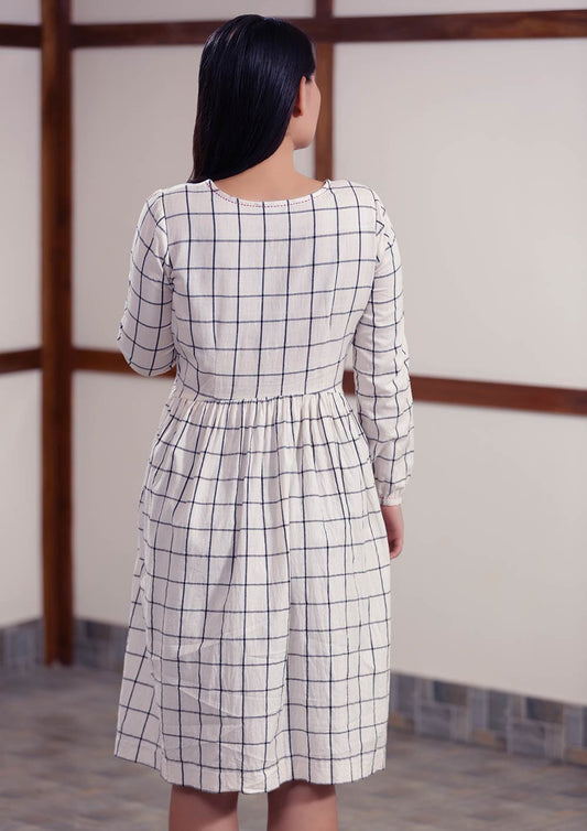 Back view of Checked peasant dress with running stitch design, designed by Khumanthem Atelier