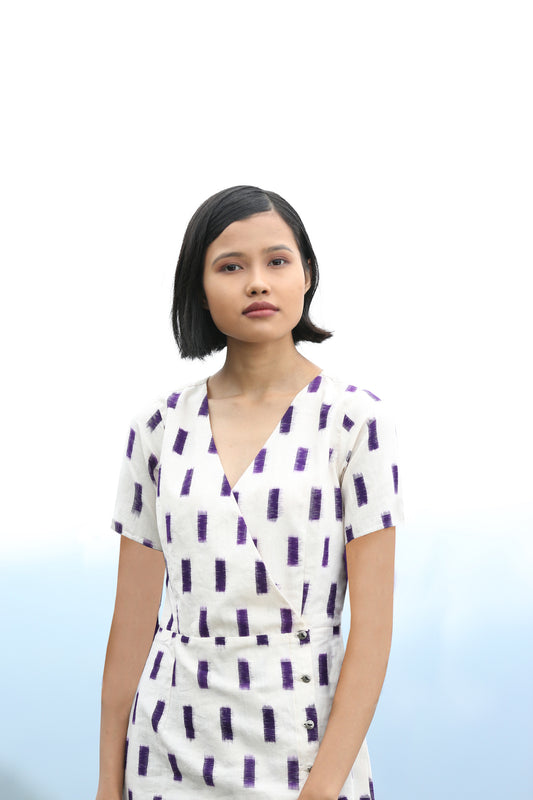 View of model wearing Handwoven Cross-over Ikat midi dress, designed by Khumanthem Atelier