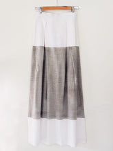 Load image into Gallery viewer, Back view of white cotton Pleated skirt with stripes, designed by Khumanthem Atelier
