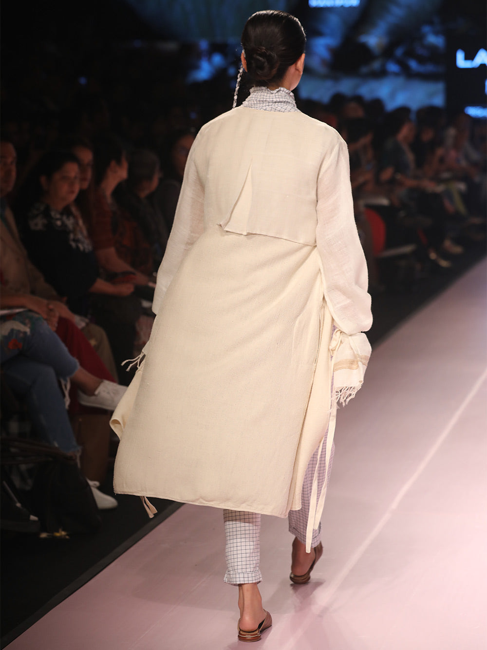 Ramp walk Back view of model wearing the off white handwoven silk coat, designed by Khumanthem Atelier, during Lakme Fashion Week, 2018