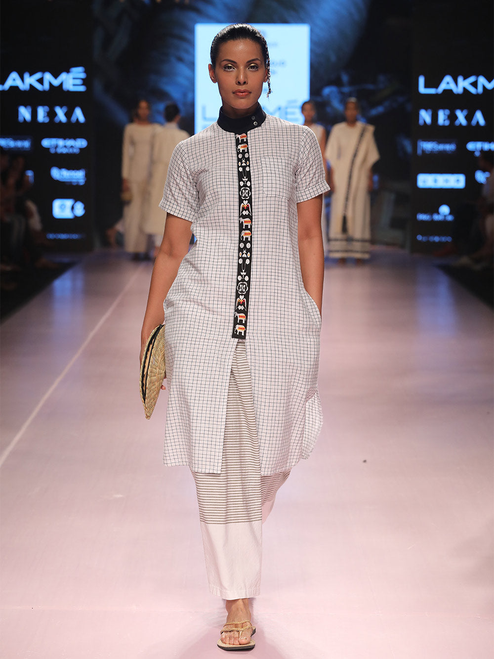 Ramp walk view of model wearing Handwoven Straight Checkered Tunic Dress (Shamee-Lanmee Motif), designed Khumanthem Atelier, during Lakme Fashion week 2018