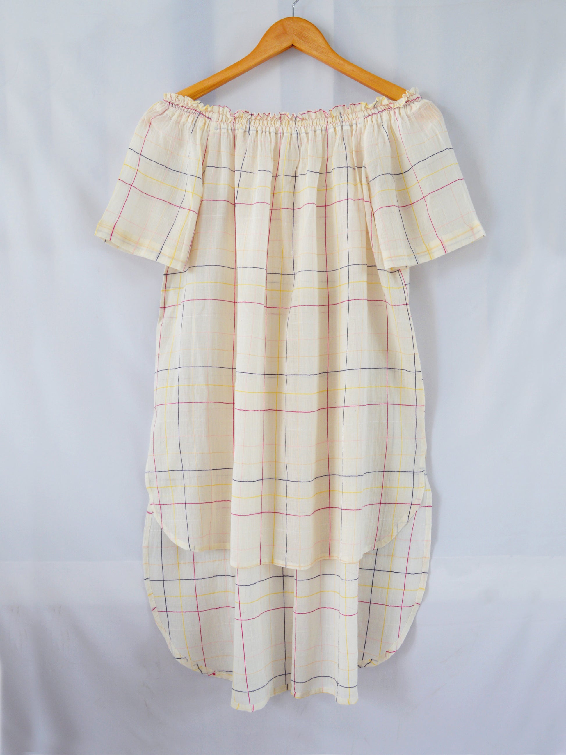 Hanger shoot Model wearing Handwoven Off-shoulder tunic with high-low hem, designed by Khumanthem Atelier, front view.